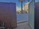 View through gate to parking lot, building, blue sky and palm trees at 4750 N Central Ave # 1N, Phoenix, AZ 85012