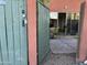 View through gate to backyard, featuring patio, unit entrance, greenery and blue sky at 4750 N Central Ave # 1N, Phoenix, AZ 85012