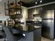 Modern kitchen boasts stainless steel appliances, dark cabinets, and black countertops at 4750 N Central Ave # 1N, Phoenix, AZ 85012