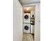 Bright laundry closet with stacked washer and dryer and white shelving at 4750 N Central Ave # 1N, Phoenix, AZ 85012