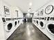 Spacious laundry room with rows of modern washing machines for residents' convenience at 4750 N Central Ave # 1N, Phoenix, AZ 85012