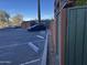 View of parking lot with black car, building, palm trees and clear blue sky at 4750 N Central Ave # 1N, Phoenix, AZ 85012