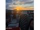 Charming rooftop dining area with comfortable chairs, offering stunning sunset views over the city skyline at 4750 N Central Ave # 1N, Phoenix, AZ 85012