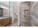 Bathroom featuring granite countertop, dual sinks, glass shower, and walk-in closet at 5100 E Rancho Paloma E Dr # 1046, Cave Creek, AZ 85331