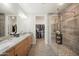 Bright bathroom with double vanity, granite countertop, and glass-enclosed shower at 5100 E Rancho Paloma E Dr # 1046, Cave Creek, AZ 85331
