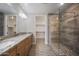 Bright bathroom features dual sinks with granite countertop and a tiled glass shower at 5100 E Rancho Paloma E Dr # 1046, Cave Creek, AZ 85331