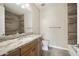 Bright bathroom features a granite countertop, wood cabinets, tile floors, and a tiled shower/tub combo at 5100 E Rancho Paloma E Dr # 1046, Cave Creek, AZ 85331