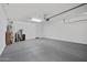 This is a two car garage with concrete floors, storage, and white walls at 5100 E Rancho Paloma E Dr # 1046, Cave Creek, AZ 85331