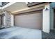 Spacious two-car garage with brown door, stone accents, and plenty of parking space at 5100 E Rancho Paloma E Dr # 1046, Cave Creek, AZ 85331