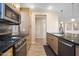 Bright kitchen features wood cabinets, granite countertops, stainless steel appliances, and a breakfast bar at 5100 E Rancho Paloma E Dr # 1046, Cave Creek, AZ 85331