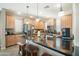 Modern kitchen with wooden cabinets, granite countertops, and a large island with stylish wood stools at 5100 E Rancho Paloma E Dr # 1046, Cave Creek, AZ 85331