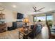 Cozy living room with neutral walls, wood-look tile flooring, and access to an outdoor balcony at 5100 E Rancho Paloma E Dr # 1046, Cave Creek, AZ 85331