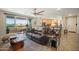 Bright living room with a comfortable brown leather couch and sliding doors leading to a balcony at 5100 E Rancho Paloma E Dr # 1046, Cave Creek, AZ 85331