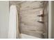 Shower with tile surround, shower curtain, built-in shelves, and modern shower head at 5100 E Rancho Paloma E Dr # 1046, Cave Creek, AZ 85331