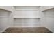 Spacious walk-in closet with wooden shelves and wood-look tile flooring at 5100 E Rancho Paloma E Dr # 1046, Cave Creek, AZ 85331