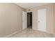 Neutral bedroom with tiled floors and a door at 5254 N 42Nd Pkwy, Phoenix, AZ 85019