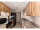 Functional kitchen with modern appliances, light wood cabinets, and durable countertops at 5254 N 42Nd Pkwy, Phoenix, AZ 85019