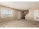 Bright living room with tile flooring, large window, and staircase access to upper level at 5254 N 42Nd Pkwy, Phoenix, AZ 85019
