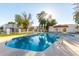 Inviting pool with crystal-clear water, framed by lush landscaping and ample deck space at 5254 N 42Nd Pkwy, Phoenix, AZ 85019