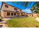 Large backyard featuring a lush lawn and a covered patio at 5749 S 249Th Dr, Buckeye, AZ 85326