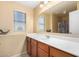 Well-lit bathroom with neutral walls, double vanity, and a large mirror at 5749 S 249Th Dr, Buckeye, AZ 85326