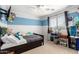 Bright bedroom with modern ceiling fan, cute decor, and window with natural light at 5749 S 249Th Dr, Buckeye, AZ 85326