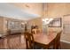 Dining area featuring a large wood table and chairs, chandelier, and hardwood floors at 5749 S 249Th Dr, Buckeye, AZ 85326