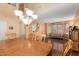 Bright dining area connects to living space with wood floors and chandelier at 5749 S 249Th Dr, Buckeye, AZ 85326