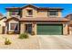 Two-story home with desert landscaping, tile roof, green shutters and a green garage door at 5749 S 249Th Dr, Buckeye, AZ 85326