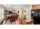 Kitchen and dining area featuring wood cabinets, granite countertops, and modern appliances at 5749 S 249Th Dr, Buckeye, AZ 85326