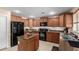Kitchen with wood cabinets, granite countertops, stainless sink, and modern appliances at 5749 S 249Th Dr, Buckeye, AZ 85326