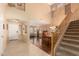 Bright, open-concept living and dining area with two-story ceilings and hardwood floors at 5749 S 249Th Dr, Buckeye, AZ 85326