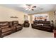 Open-concept living room showcases plush couches, tan carpet, and neutral color palette at 5749 S 249Th Dr, Buckeye, AZ 85326