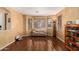 Spacious living room with hardwood floors, neutral walls, and a cozy seating area near bay windows at 5749 S 249Th Dr, Buckeye, AZ 85326