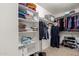 Spacious walk-in closet with shelves and rods for ample storage and organization at 5749 S 249Th Dr, Buckeye, AZ 85326