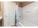 Cozy bathroom features a shower-tub combo with white tile and floral shower curtain at 581 W Angus Rd, San Tan Valley, AZ 85143