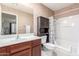 Well-lit bathroom with a vanity, toilet, a vanity and a shower-tub combo at 581 W Angus Rd, San Tan Valley, AZ 85143