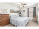 Comfortable bedroom featuring a ceiling fan, wood dresser, and calming wall decor at 581 W Angus Rd, San Tan Valley, AZ 85143