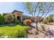 Inviting single-story home with a well-manicured lawn and mature desert landscaping at 581 W Angus Rd, San Tan Valley, AZ 85143