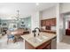 Open-concept kitchen with island, dining area, and a view of the living room at 581 W Angus Rd, San Tan Valley, AZ 85143