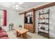 Cozy living room with a TV, built-in shelving, and a ceiling fan at 581 W Angus Rd, San Tan Valley, AZ 85143