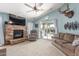 Cozy living room with fireplace, ceiling fan and access to the backyard at 581 W Angus Rd, San Tan Valley, AZ 85143