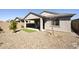 Beautiful home backyard featuring a covered patio, well-maintained desert landscaping and a small artificial lawn at 5854 S Del Rancho --, Mesa, AZ 85212