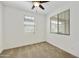 Bedroom with a ceiling fan, carpeted floor, and natural light streaming through two windows at 5854 S Del Rancho --, Mesa, AZ 85212
