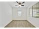 Empty bedroom with a ceiling fan, carpeted floor, and natural light from two windows at 5854 S Del Rancho --, Mesa, AZ 85212