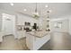 Open-concept kitchen features a spacious island, white cabinetry, and modern appliances at 5854 S Del Rancho --, Mesa, AZ 85212