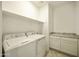 Functional laundry room with appliances, storage cabinets, and granite countertops at 5854 S Del Rancho --, Mesa, AZ 85212