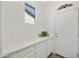 Mud room features generous white cabinets and counters, next to a door with direct access to the outdoors at 5854 S Del Rancho --, Mesa, AZ 85212