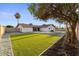 Backyard featuring well-maintained turf, rock landscaping, and a view of the home's exterior at 6134 E Hannibal St, Mesa, AZ 85205