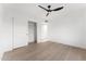 A minimalist bedroom features bright natural light, a ceiling fan, and built-in closet at 6134 E Hannibal St, Mesa, AZ 85205